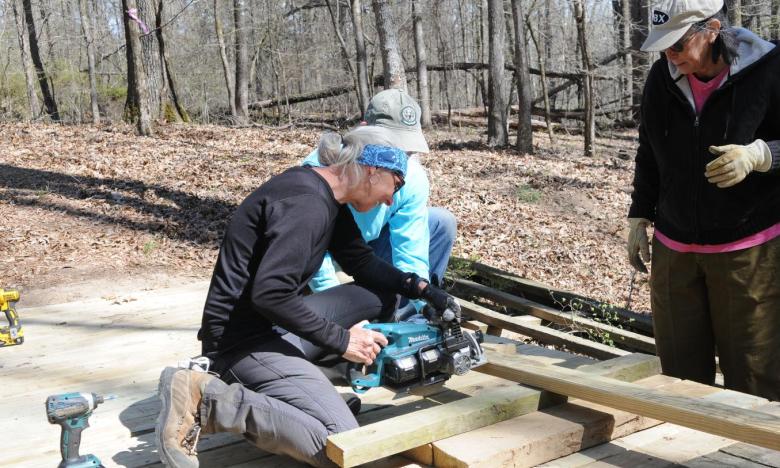 Members of the volunteer crew helped with bridge repairs on the Cane Creek Lake Trail at Cane Creek State Park. 